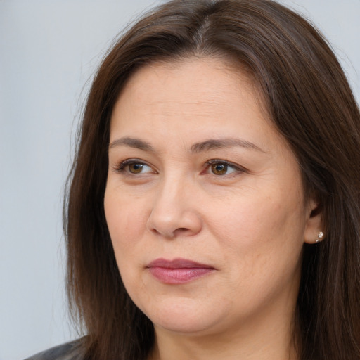 Joyful white adult female with long  brown hair and brown eyes
