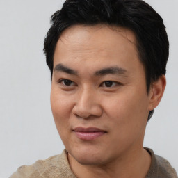 Joyful asian young-adult male with short  black hair and brown eyes