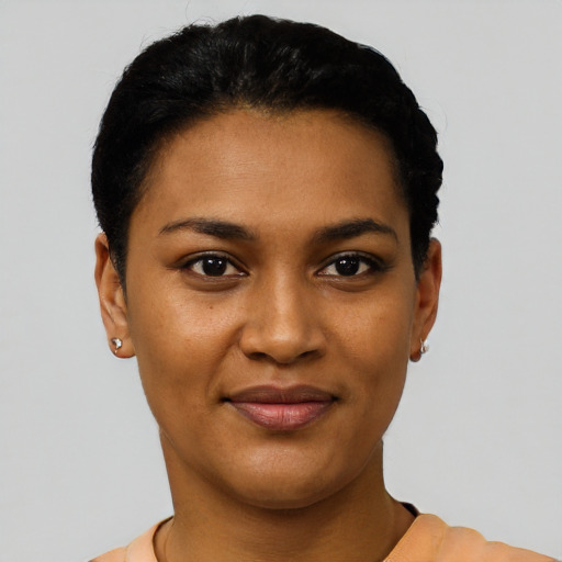 Joyful black young-adult female with short  black hair and brown eyes