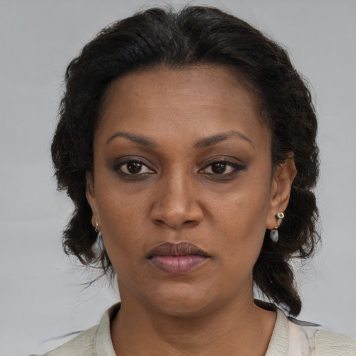Neutral black adult female with medium  brown hair and brown eyes