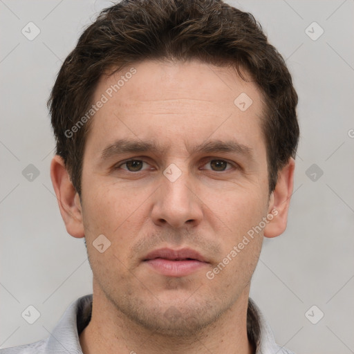 Joyful white adult male with short  brown hair and grey eyes