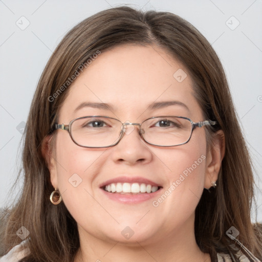 Joyful white adult female with long  brown hair and grey eyes