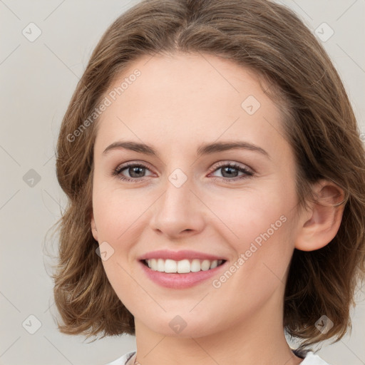 Joyful white young-adult female with medium  brown hair and green eyes