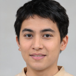 Joyful asian young-adult male with short  brown hair and brown eyes