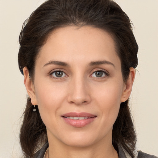 Joyful white young-adult female with medium  brown hair and brown eyes