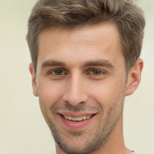 Joyful white young-adult male with short  brown hair and brown eyes