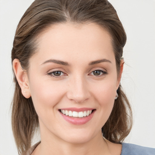 Joyful white young-adult female with medium  brown hair and grey eyes