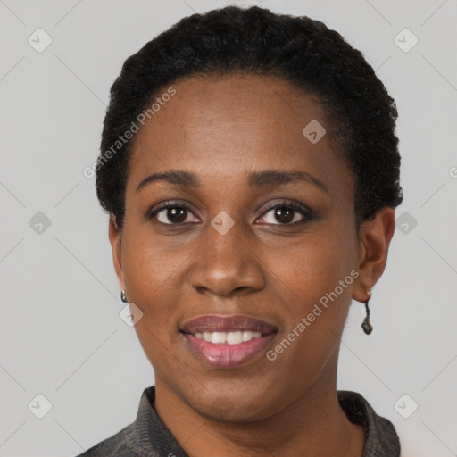 Joyful black young-adult female with short  black hair and brown eyes