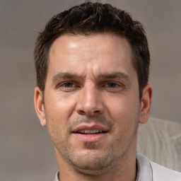 Joyful white adult male with short  brown hair and brown eyes