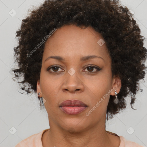 Joyful black adult female with short  brown hair and brown eyes