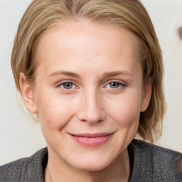 Joyful white young-adult female with medium  brown hair and blue eyes