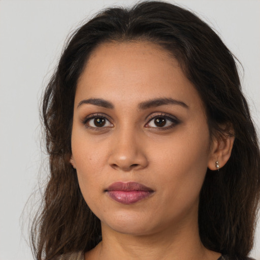 Neutral latino young-adult female with long  brown hair and brown eyes