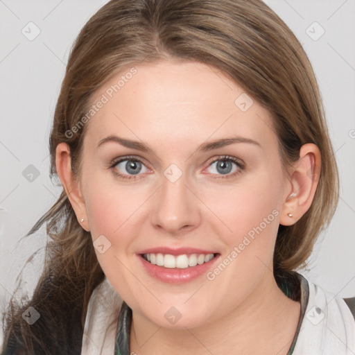 Joyful white young-adult female with medium  brown hair and blue eyes