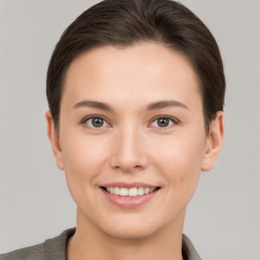 Joyful white young-adult female with short  brown hair and brown eyes