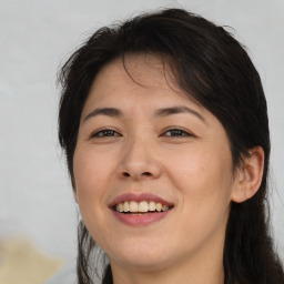 Joyful asian young-adult female with long  brown hair and brown eyes