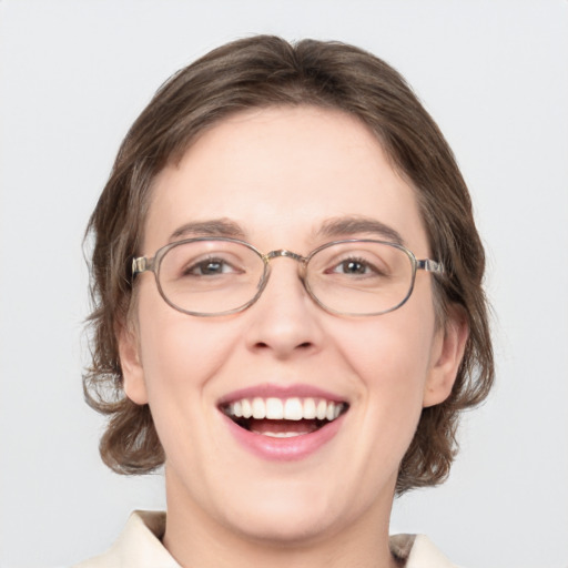 Joyful white adult female with medium  brown hair and green eyes