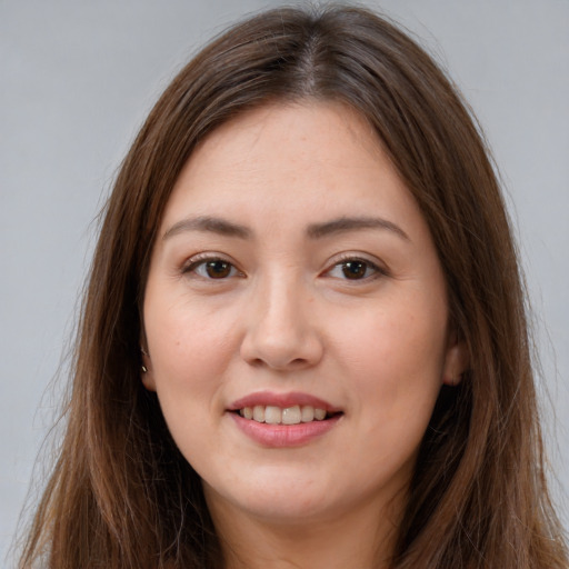 Joyful white young-adult female with long  brown hair and brown eyes