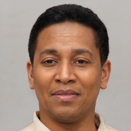 Joyful latino adult male with short  brown hair and brown eyes