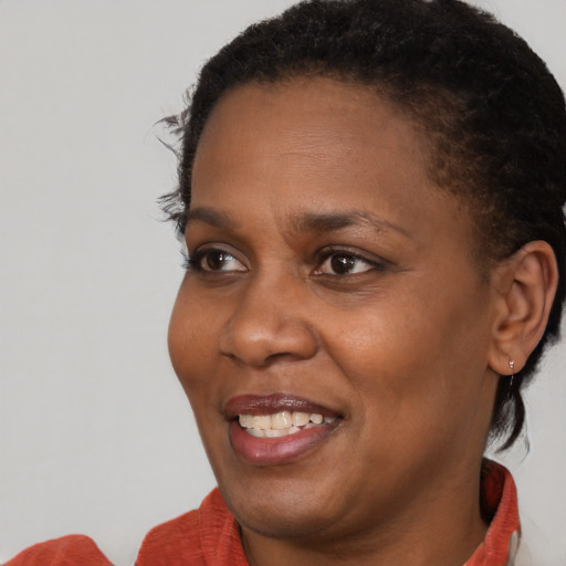 Joyful black young-adult female with short  brown hair and brown eyes