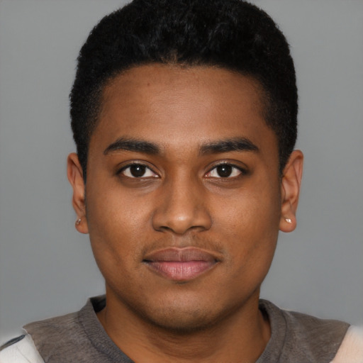 Joyful black young-adult male with short  black hair and brown eyes