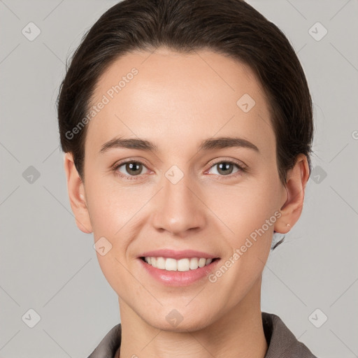 Joyful white young-adult female with short  brown hair and brown eyes