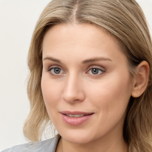 Joyful white young-adult female with long  brown hair and blue eyes