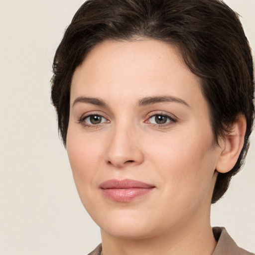 Joyful white young-adult female with medium  brown hair and brown eyes