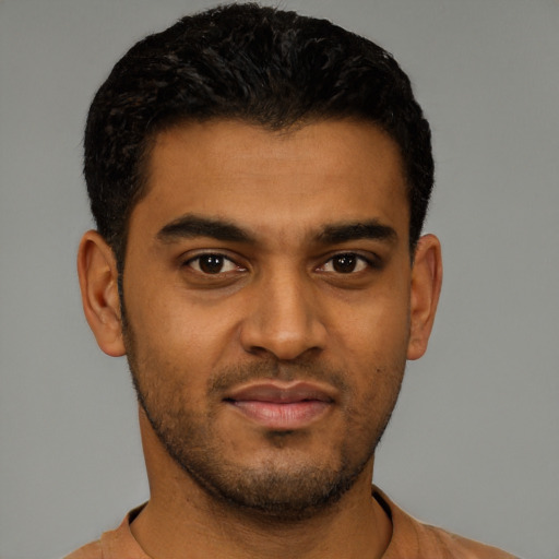 Joyful latino young-adult male with short  black hair and brown eyes