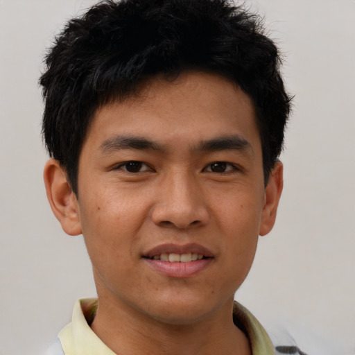 Joyful asian young-adult male with short  black hair and brown eyes