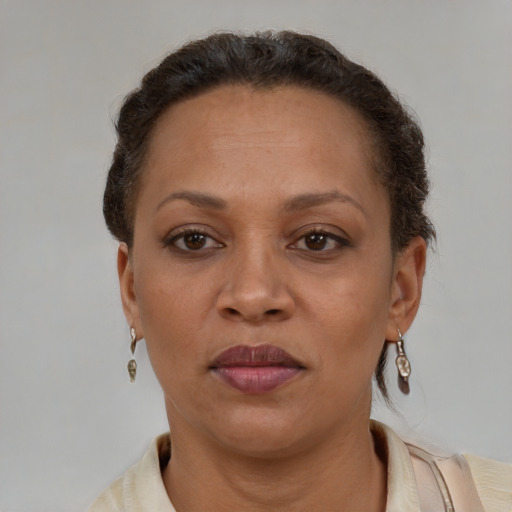 Joyful latino adult female with short  brown hair and brown eyes