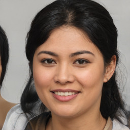 Joyful asian young-adult female with medium  brown hair and brown eyes