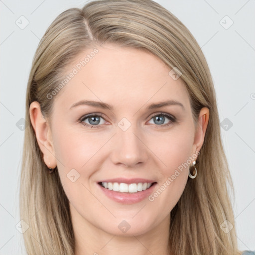 Joyful white young-adult female with long  brown hair and blue eyes