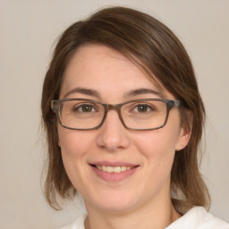 Joyful white young-adult female with medium  brown hair and green eyes