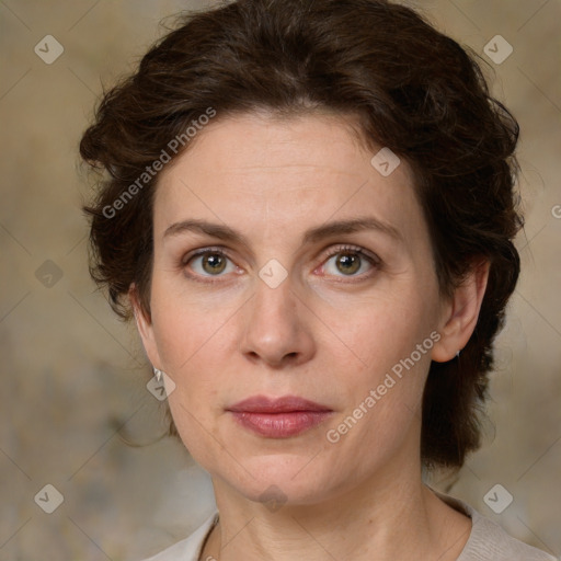 Joyful white adult female with medium  brown hair and green eyes