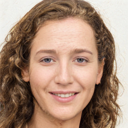 Joyful white young-adult female with long  brown hair and green eyes