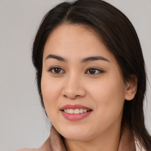 Joyful asian young-adult female with long  brown hair and brown eyes