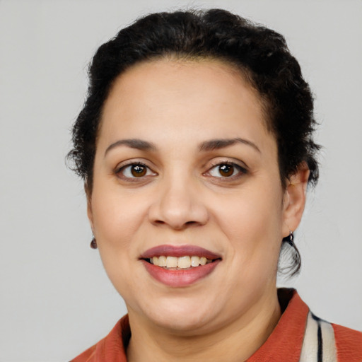 Joyful latino young-adult female with short  brown hair and brown eyes