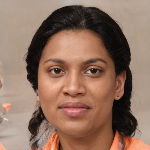 Joyful latino adult female with medium  brown hair and brown eyes