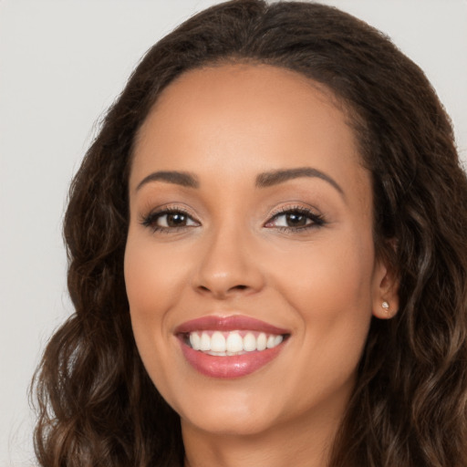 Joyful white young-adult female with long  brown hair and brown eyes