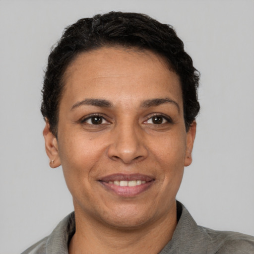 Joyful white adult female with short  black hair and brown eyes