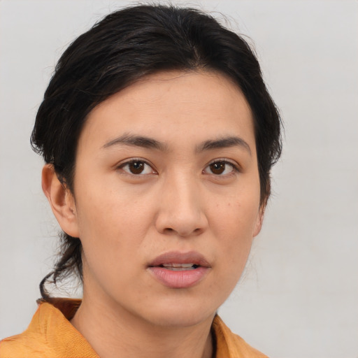Joyful asian young-adult female with medium  brown hair and brown eyes