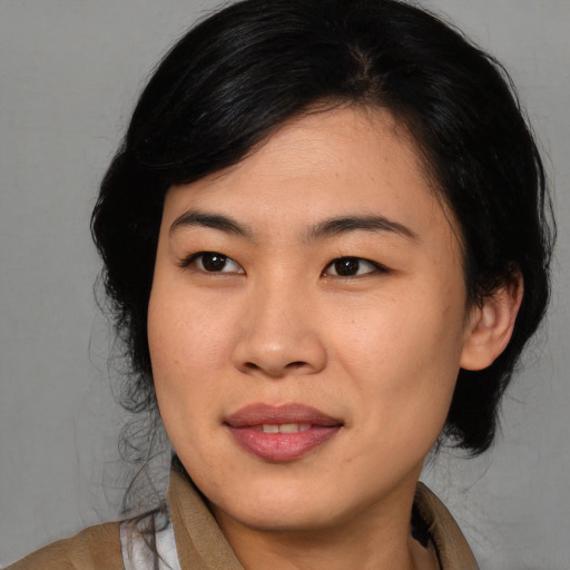 Joyful asian young-adult female with medium  black hair and brown eyes