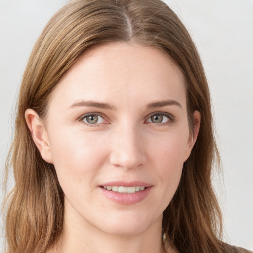 Joyful white young-adult female with long  brown hair and blue eyes