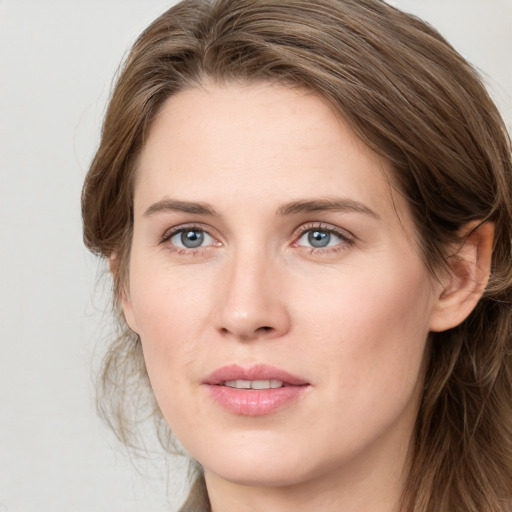 Joyful white young-adult female with long  brown hair and green eyes