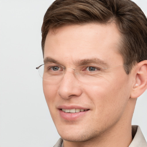 Joyful white adult male with short  brown hair and grey eyes