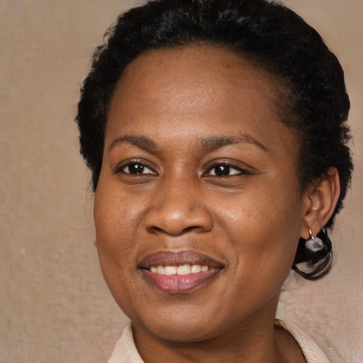 Joyful black young-adult female with short  brown hair and brown eyes