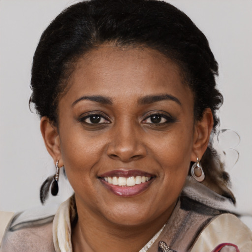 Joyful black young-adult female with medium  brown hair and brown eyes