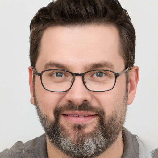 Joyful white adult male with short  brown hair and grey eyes