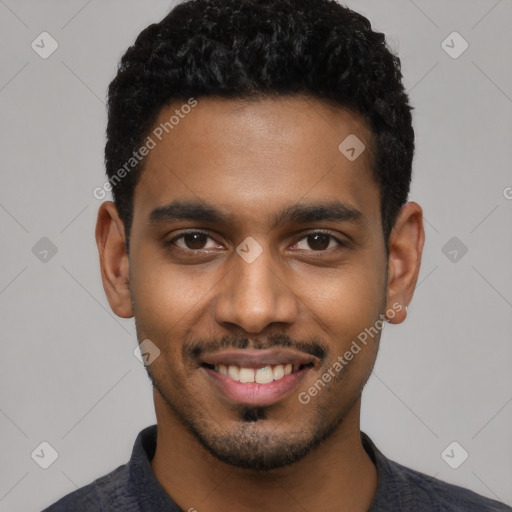 Joyful black young-adult male with short  black hair and brown eyes