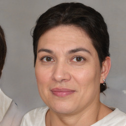 Joyful white adult female with medium  brown hair and brown eyes